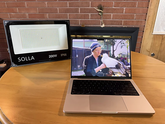 A 200W LED panel behind and beside a laptop