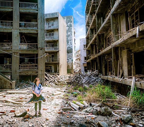 Girl exploring modern ruins at Gunkanjima Island
