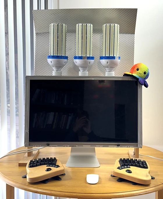 Homemade SAD lamp with three corn bulbs, behind monitor