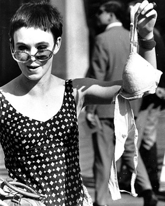Protester drops a bra in the trash at the 1968 Miss America Pageant